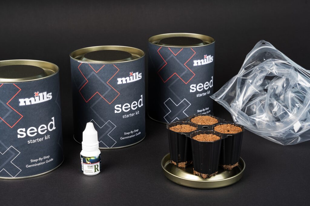 Mills Seed Starter Kit tins with black design and red X branding on dark background.